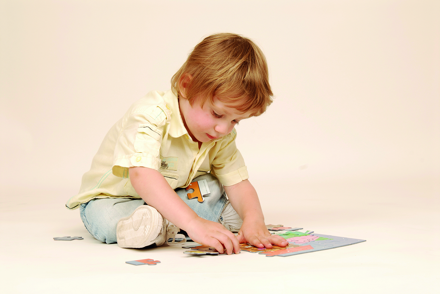 Child doing jigsaw puzzle